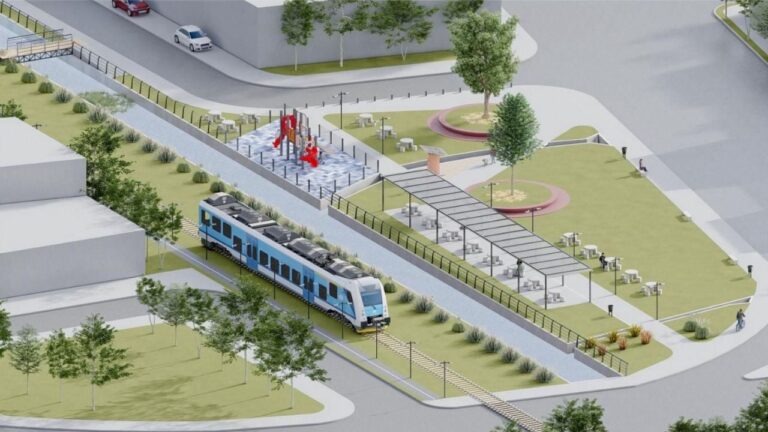 Obras de urbanización y construcción en la calle Mazzoni, Neuquén, con maquinaria y trabajadores.